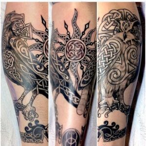 Leg tattoo in black and gray ink of a celtic knotwork design featuring a raven, owl, and sun by Jaesun Duggan