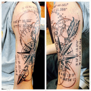 Arm tattoo in black and gray ink of a compass, arrow, bubbles, and geographic number coordinates by Jaesun Duggan