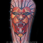 Geometric lion head arm tattoo in color ink by Natan Alexander